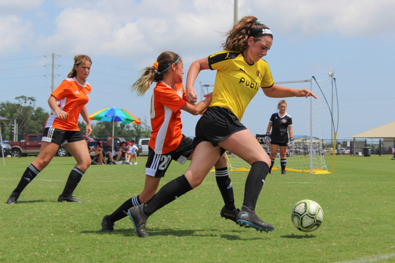 girl soccer player being challenged on field