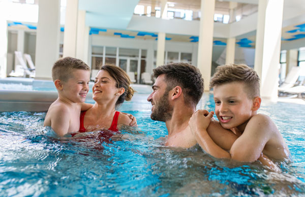 family in hotel pool