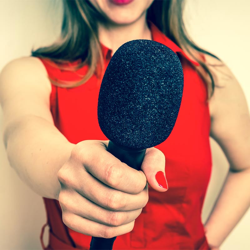 woman reporter holding microphone